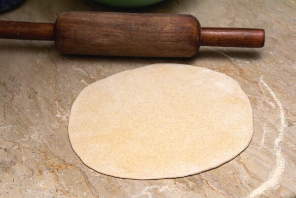 brown wooden rolling pin on brown wooden table