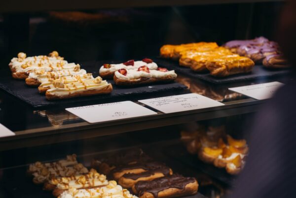 brown and white pastries on black tray